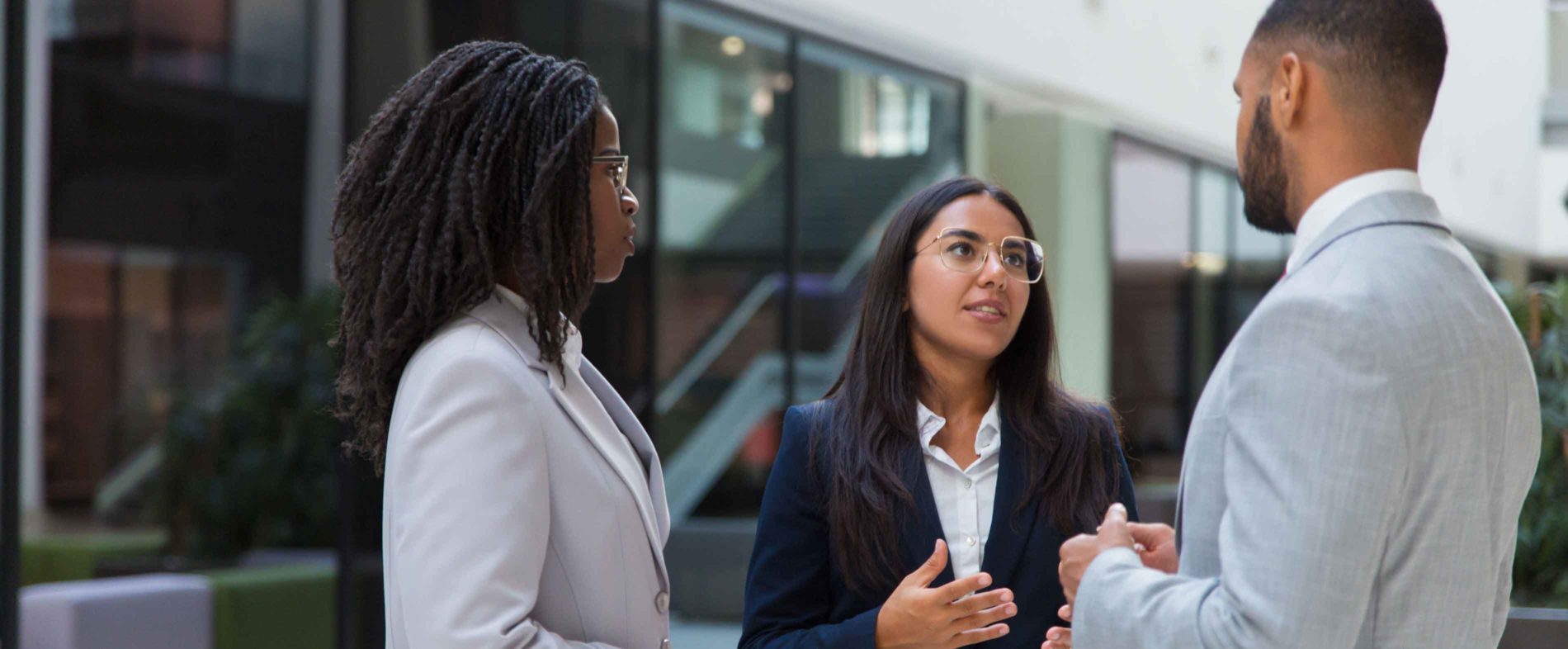 Diverse group of young professionals having a discussion outside