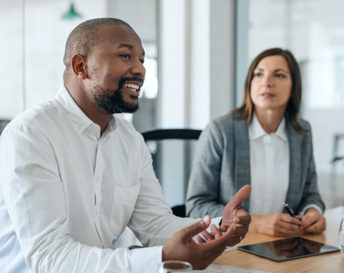 a Black man speaking in a work meeting