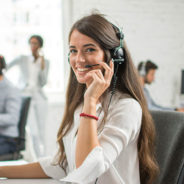 A woman wearing a headset and smiling